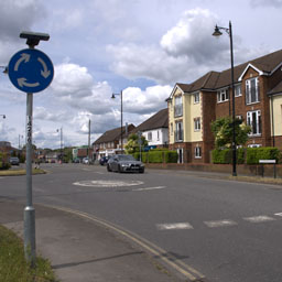 car driving towards a roundabout