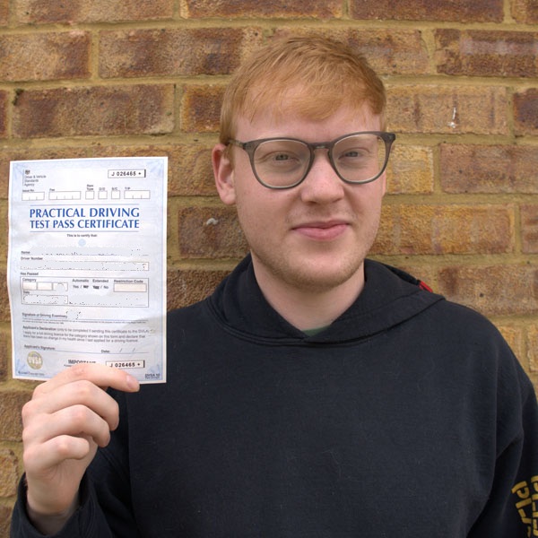 happy StreetSafe Driving School student holding practical driving test pass certificate
