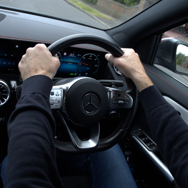 StreetSafe Driving School New driver with hands on steering wheel of new car